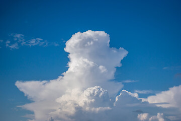 Beautiful white anime-looking clouds over a blue sky for the background.