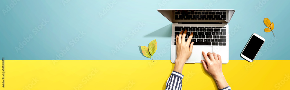 Poster autumn leaves with person using a laptop computer from above