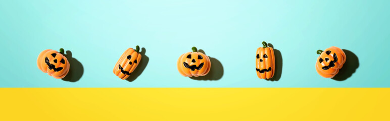 Miniature Halloween pumpkin ghosts - overhead view flat lay