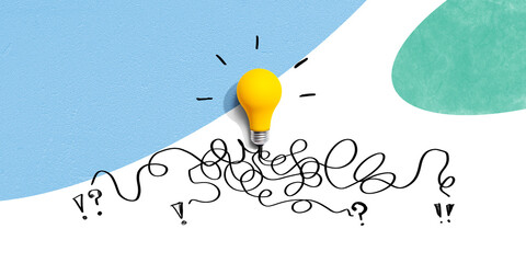 Brainstorming concept with a yellow light bulb - Flat lay