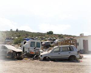 Junk yard with many wrecked cars. The concept of waste and recyclable materials processing