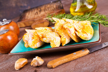 raw chicken wings on stone background