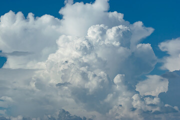 Beautiful white anime-looking clouds over a blue sky for the background.