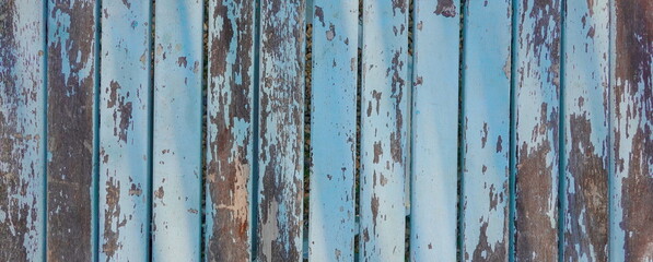 Aged Patina on Weathered Blue Wooden Boards. The Rustic Charm of Faded Paint and Time-Worn Wood