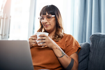 Glasses, relax and woman with tablet, coffee and typing on app, smile and creative in home and...