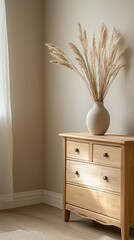 Interior of modern living room with beige wall, wooden chest of drawers, vase with dried flowers and plant