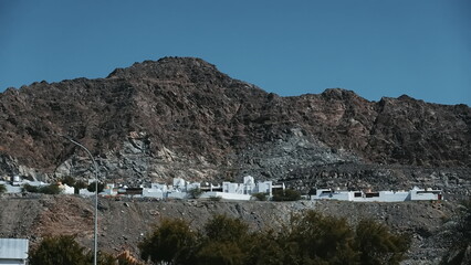 Desert Mountain Landscape With White Buildings In Foreground
