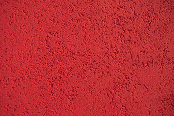 Red wall texture. Red rough background. Red grain surface. Concrete red wall. Texture of the wall.