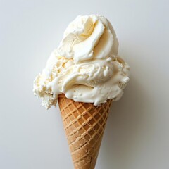 A scoop of vanilla ice cream on a waffle cone, with swirls suggesting it's soft and fluffy.