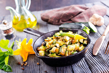 Baked vegetables in pan on a table, close up view