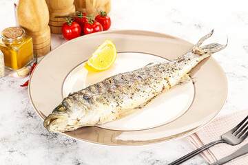 Grilled sea bass fish served lemon