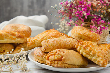 Plate with homemade pastries on a light table. Sweet breakfast