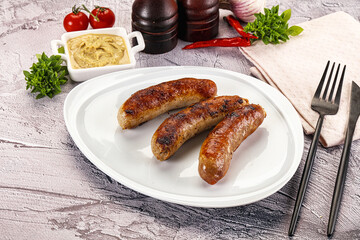Delicous natural roasted sausages in the plate