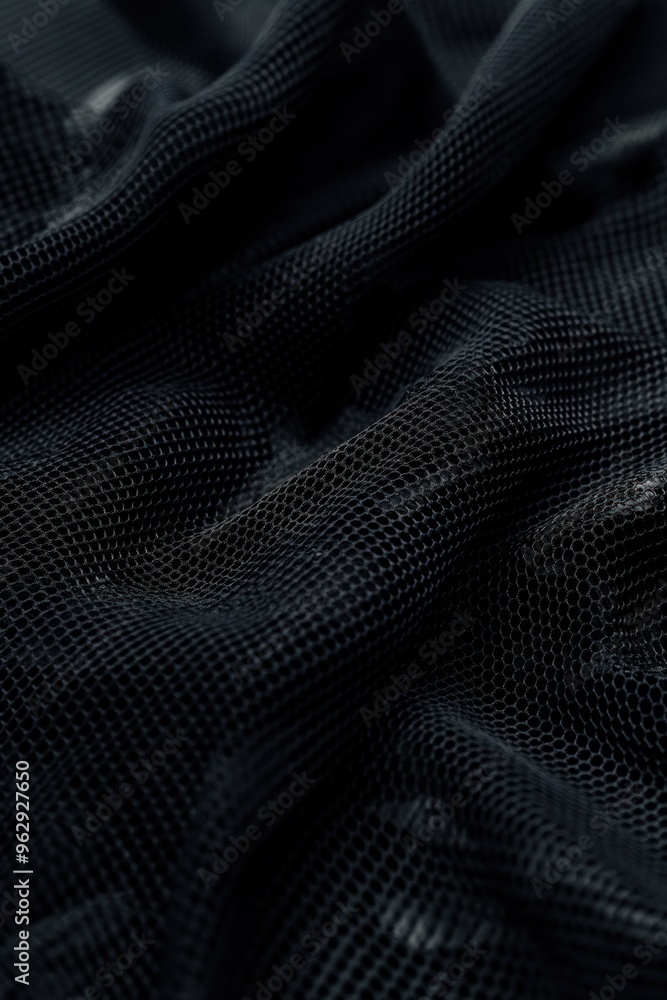 Poster Black fabric with grid pattern shows smooth texture and natural weave. High-quality material highlighted by blurred background. Suitable for fashion, sports, and abstract uses.