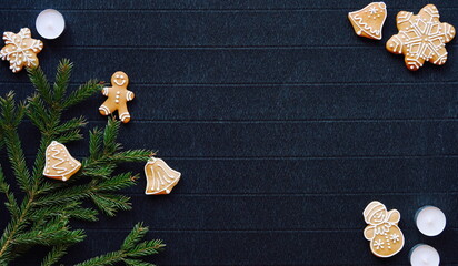 Gingerbread and Christmas tree branches on a dark paper craft background. Happy New Year Banner