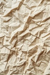 Obraz premium Crumpled beige paper texture with folded edges, blurred background. Close-up view of handmade craft material for DIY projects, art, and design. Ideal for creative backgrounds, textures, and patterns.