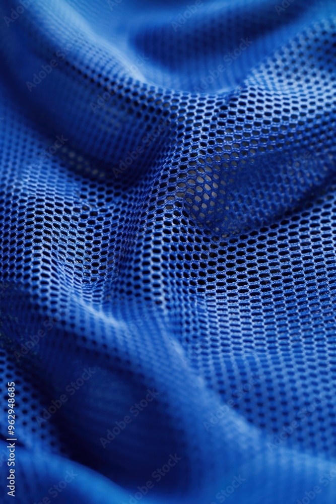 Poster close-up of blue sports fabric with grid pattern. wrinkled texture adds depth to image. small holes 