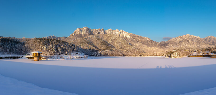 Panoramic and morning view of snow covered Wonam Reservoir with the background of Ulsanrock of Seoraksan Mountain near Goseong-gun, South Korea