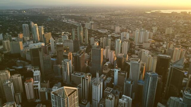 Aerial view of skyscrapers buildings in Makati business district and Manila city at sunset, capital of Philippines, 4k