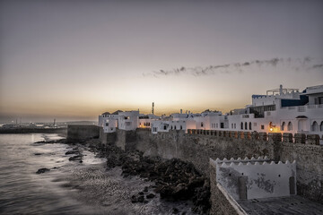 Asilah or Assilah at dawn. Sunrise over the Medina of a beautiful Moroccan marine city. Moroccan Atlantic coast, Tangier or Tanger province.	