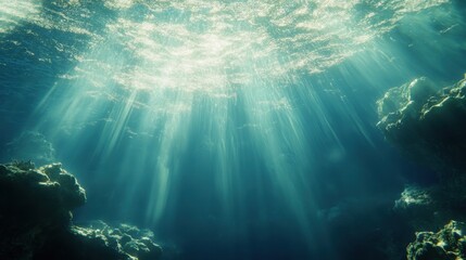 Deep underwater scene with sunlight filtering through the water's surface, illuminating the textures below.