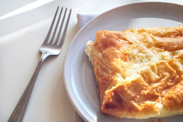 khachapuri with cheese in a plate on the table