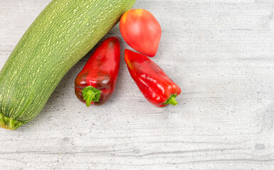 Zucchini, tomato and red pepper on the kitchen table