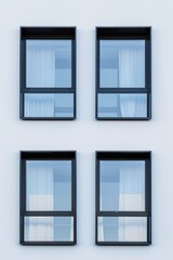 Obraz premium Four windows with black frames and white curtains