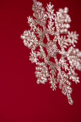 background made of hanging christmas decoration over a red background