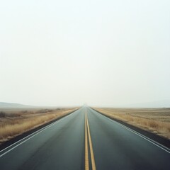 Endless Road: A solitary highway stretches into the distance, vanishing into the ethereal haze of a foggy horizon. The empty asphalt evokes a sense of freedom, opportunity, and the unknown. The minima