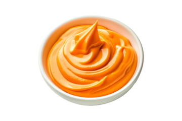 Closeup of creamy orange dipping sauce or Sriracha mayonnaise in a white bowl isolated on white transparent background. Concept of food, dip, condiment, and cuisine