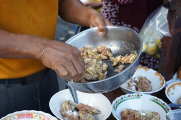 A street food vendor in Surabaya, Indonesia, is preparing a hearty soup