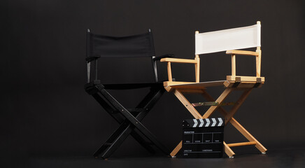 Two director chair with clapper board on black background