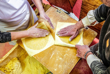 Basque farmers (Baserritarras) making Talos, a Basque tortilla stuffed with fresh chorizo called...
