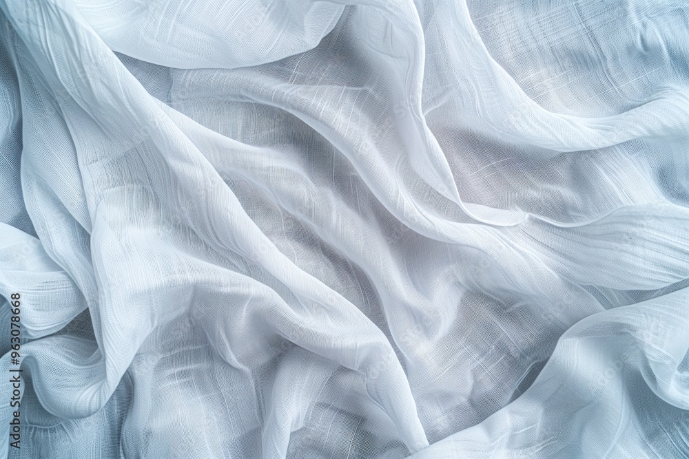 Aufkleber close-up view of white fabric with subtle texture, folded to intricate design. fabric dominates gray