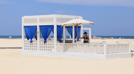 seaside resort beach with white sand and a gazebo for relaxation
