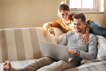 Couple, relax and laptop on sofa for shopping, streaming and family video call in home. Man, happy woman and computer in living room for connectivity, hug and tech for communication or choosing media