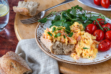 Scrambled eggs with smoked salmon, roasted tomatoes and crusty bread