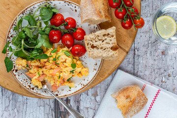 Scrambled eggs with smoked salmon, roasted tomatoes and crusty bread
