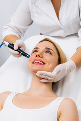 Relaxing beauty treatment in a modern cosmetic clinic. Woman enjoying a hydrolifting procedure, achieving radiant and youthful skin. Perfect for showcasing advanced skincare solutions.