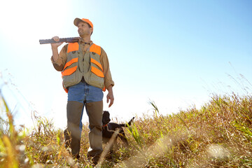 Man, dog and bush for hunting hobby, shotgun practice and stalking prey together in nature. Mature...