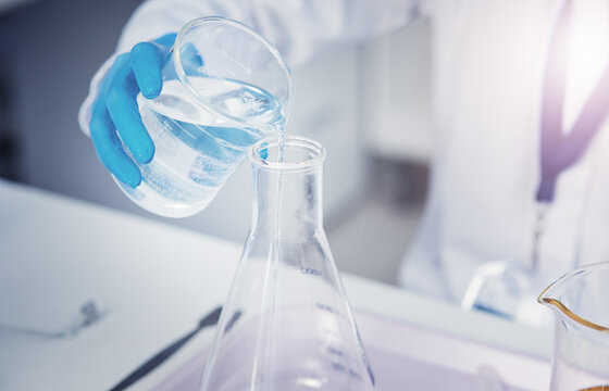 Science, hand of person and beaker with chemical for experiment, medicine development and research. Scientist, glass and adding liquid in lab for formula, transfer and investigation in chemistry