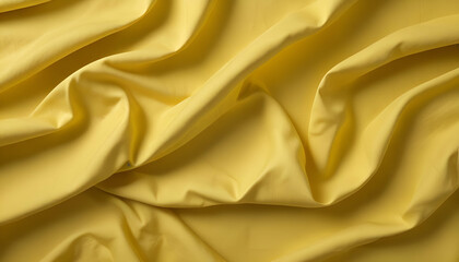 Obraz premium Crumpled yellow fabric with folds and creases creating an abstract textured pattern