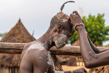 Ethiopia, man from the Karo tribe with typical head decoration and face paintings in his village in the  Omo Valley. 21 th of february 2024