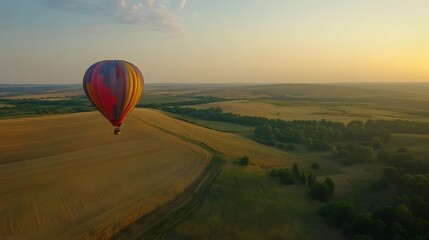 Obraz premium 7. An old-fashioned hot air balloon rising over a vast, open countryside