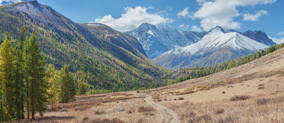 Autumn landscape, mountain valley, snow-capped peaks, sunny day