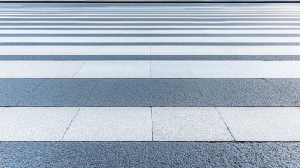 Fototapeta premium A modern urban landscape features horizontal white lines of a crosswalk on an empty asphalt road in China, showcasing a serene city square without traffic