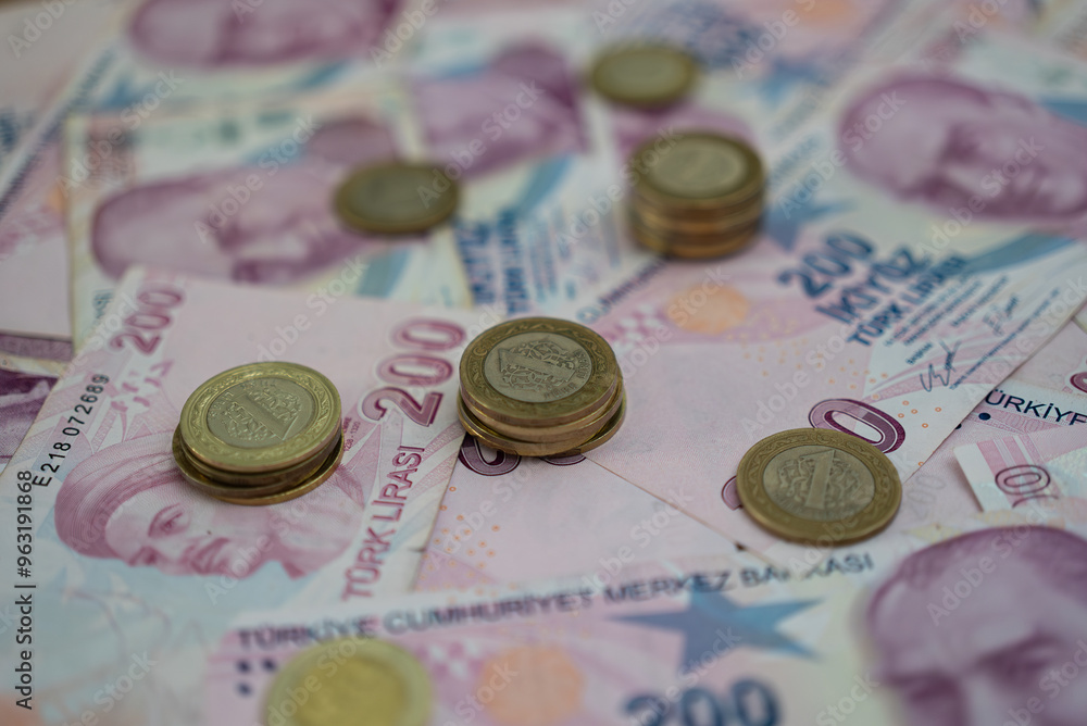 Poster piles of golden coins placed on turkish lira banknotes indicating concept of volatile currency with 