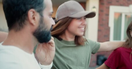 Up close happy brunette girl in a cap and green T-shirt dances and has fun with her friends at a party in the courtyard of the house
