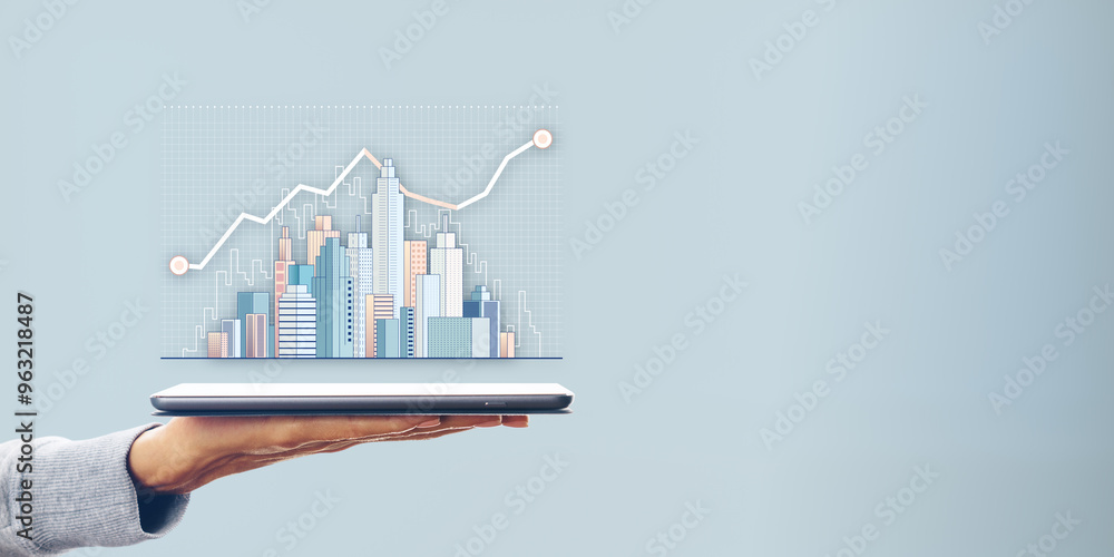 Poster hand holding a tablet displaying a city skyline with data charts on a plain blue background.